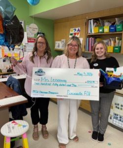 PFCU employees presenting a big check to Mrs. Leisenring